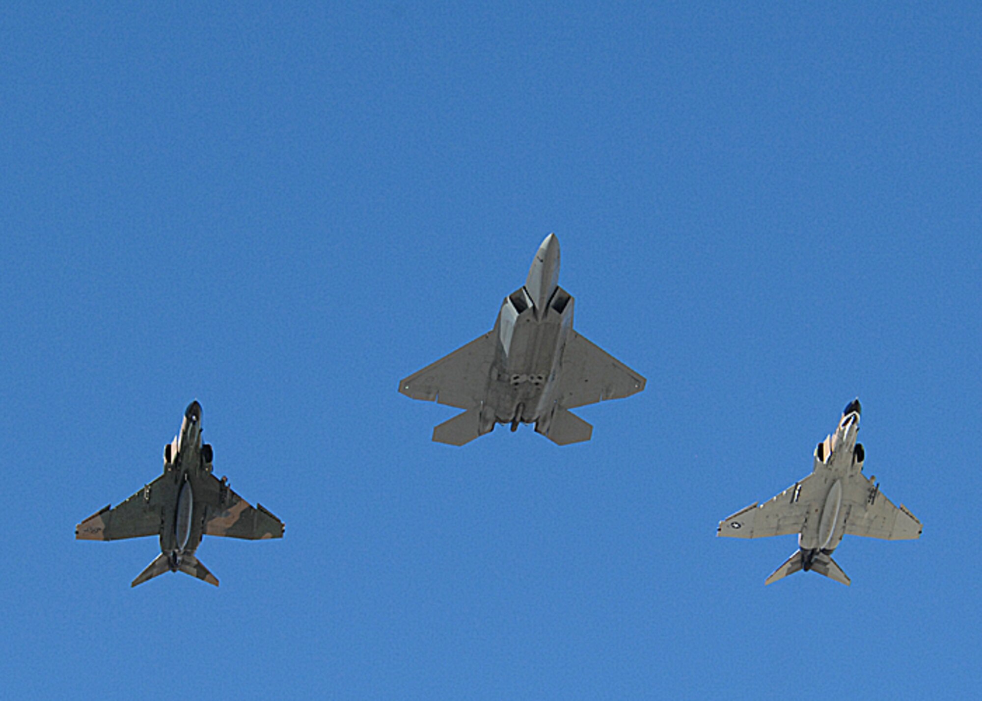 An F-22A Raptor from Holloman Air Force Base, N.M., and two F-4's fly over the New Mexico State Aggie's football stadium Nov. 8 in Las Cruces, N.M..   The F-22A and the F-4's flew over the stadium after the National Anthem played.  (U.S. Air Force photo by Airman 1st Class John D. Strong II)