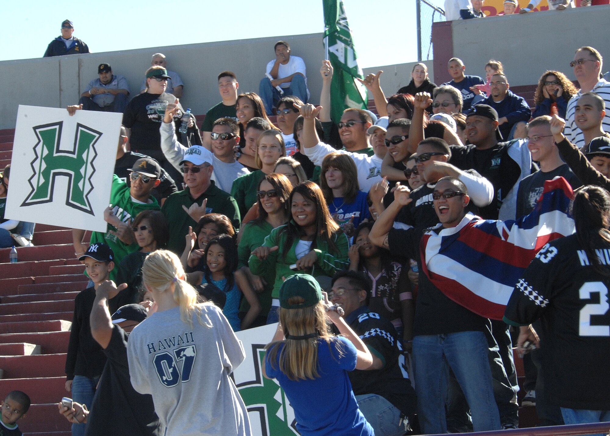 Members of Holloman Air Force Base, N.M., cheer for the Hawaii Warriors during their game against the New Mexico State University Aggies, Nov. 8, at New Mexico State University in Las Cruces, N.M.  The Warriors went on to win the game 42-30.  (U.S. Air Force photo by Airman 1st Class John D. Strong II)