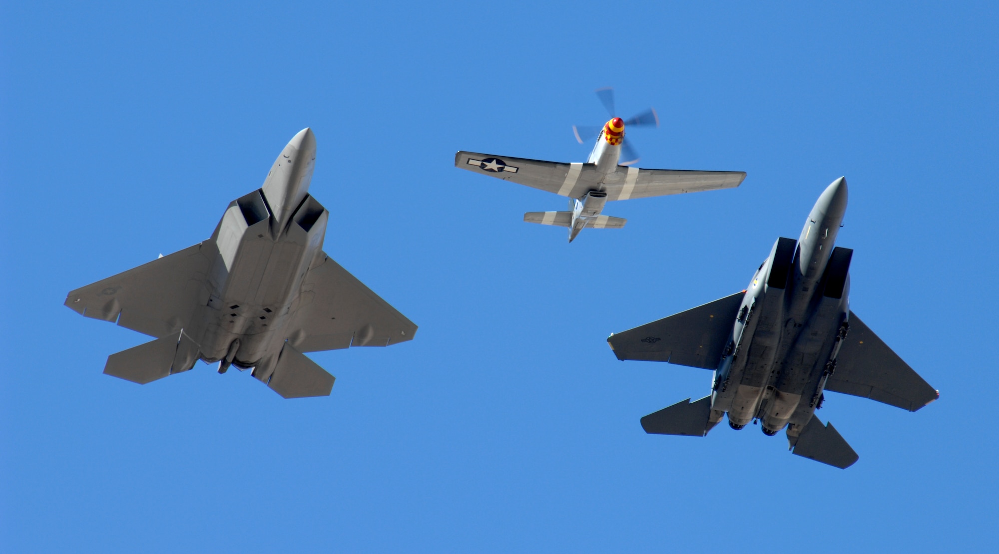 (from left to right) A F-22 Raptor, P-51 Mustang and F-15E Strike Eagle perform the historic heritage flight during an air show at Nellis Air Force Base, Nev., Nov. 8, 2008. The Nellis AFB air show showcased the 21st-century Air Force’s capabilities in air, space and cyberspace. The show, held Nov. 8-9. is the largest aviation event in Las Vegas and the largest free public event in Nevada.

(U.S. Air Force Photo/Senior Airman Larry E. Reid Jr., Released)
(U.S. Air Force Photo/Senior Airman Larry E. Reid Jr., Released)