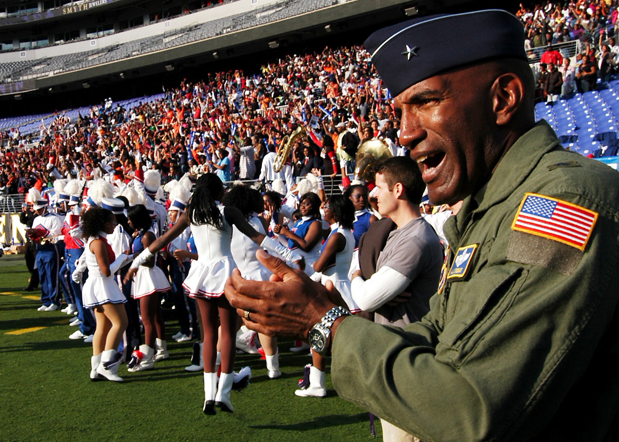 Air Force Recruiting Service Commander Brig. Gen. A.J. Stewart cheers the Engineers, Baltimore Polytechnic Institute high school’s football team, following its 16-13 win at M&T Bank Stadium Nov. 8. The Engineers battled its 119-year rival, the Baltimore City College high school Knights in the Air Force-sponsored iHigh Great American Rivalry Series. A Class of 1977 BPI alumni and varsity football wide receiver, General Stewart shared inspirational words with both teams before the game, and he presented one of two $500 college scholarships to Engineers player Arnold Farmer. (U.S. Air Force photo/Tech. Sgt. Jennifer Lindsey)