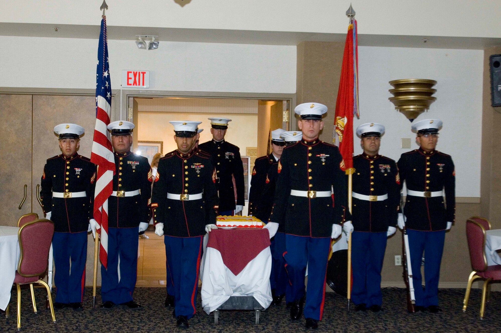 Honor guard members with the Marine Corps present the cake during the service's 233rd birthday celebration Nov. 7 at Club Muroc here. Originally founded on Nov. 10, 1775, the Marine Corps was composed mainly of infantrymen serving aboard Navy ships. They were primarily responsible for the security of the ship, offensive and defensive boarding parties. They also helped protect the ship's officers from mutiny. (Air Force photo by Kevin North)
