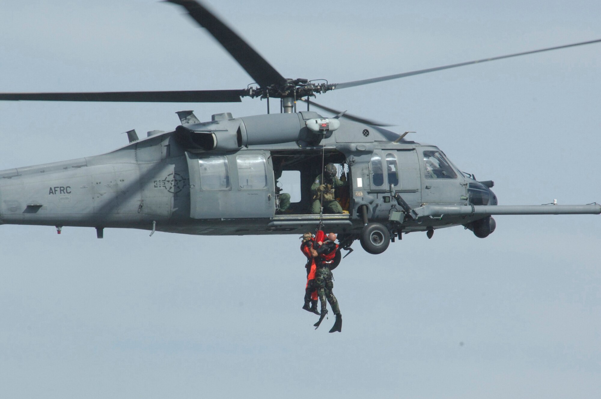 KENNEDY SPACE CENTER, Fla. - Air Force Reservists from the 920th Rescue Wing based at Patrick Air Force, Fla. were among a professional lineup of aerial acts that drew approximately 20,000 to the Space Coast Nov. 7-9.  It was the 2nd Annual Space and Air Show at Kennedy Space Center.  The Reserve Airmen demonstrated an astronaut recovery mission.  Shown here, a downed astronaut gets rescued by Rescue Wing Airmen who rush to the scene in their HH-60G Pave Hawk helicopter.  Pararescuemen hoist the astronaut to safety. (U.S. Air Force Photo/Jim Massoni)