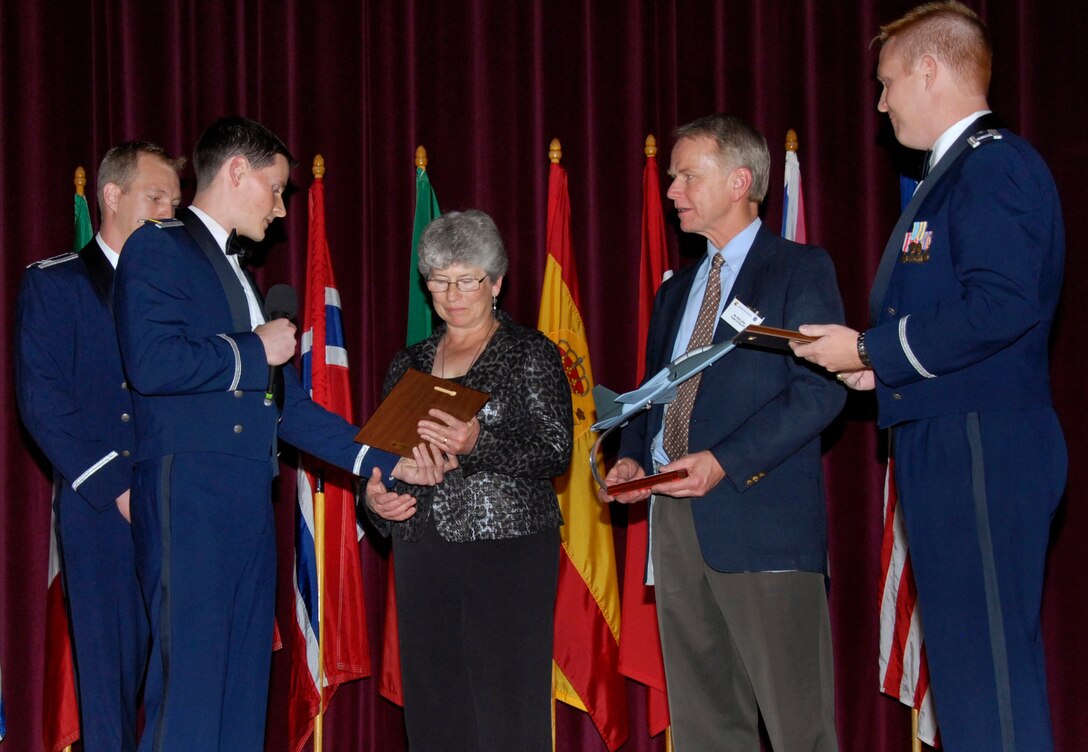 Capt. Barak Amundson and 2nd Lt. Ryan Bodenheimer present Penny Farquhar with a placque that memorializes her son, 2nd Lt. Alec Littler, while Bob Littler and Capt. Michael Hansen watch. The 80th Flying Training Wing honored Lieutenant Littler Nov. 7 during the Euro-NATO Joint Jet Pilot Training Program's graduation of Class 08-08. The lieutenant, who was killed during a May 1 training mission, was scheduled to graduate with Class 08-08. (U.S. Air Force photo/Harry Tonemah)