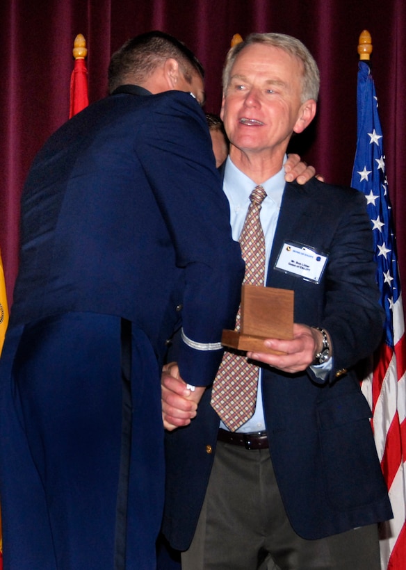 Second Lt. Ryan Bodenheimer shakes Bob Littler's hand and gives him a hug after presenting him with his son's, 2nd Lt. Alec Littler, wings posthumously during a ceremony at the Euro-NATO Joint Jet Pilot Training Porgram graduation Nov. 7 at the base theater. Lieutenant Littler was killed May 1 during a T-38 Talcon crash. He would have graduated with Class 08-08. (U.S. Air Force photo/Harry Tonemah)