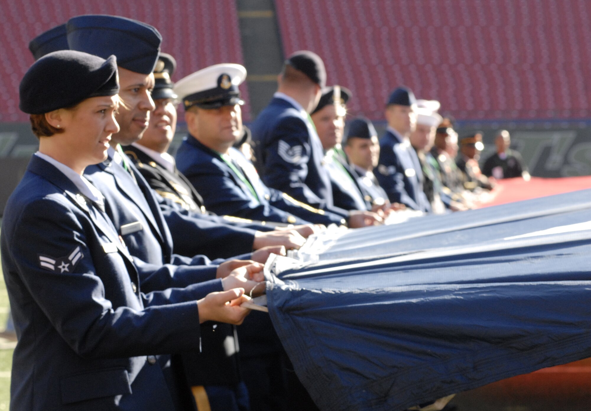 Airman 1st Class Amanda Bacinsky holds the end of an American flag during the pregame rehearsal for the New York Jets military appreciation football game at Meadowlands Stadium in New Jersey Nov. 9. Airman Bacinsky, along with 59 other servicemembers, unveiled the flag during the game's opening ceremony. (U.S. Air Force photo/Staff Sgt. Monique Randolph) 