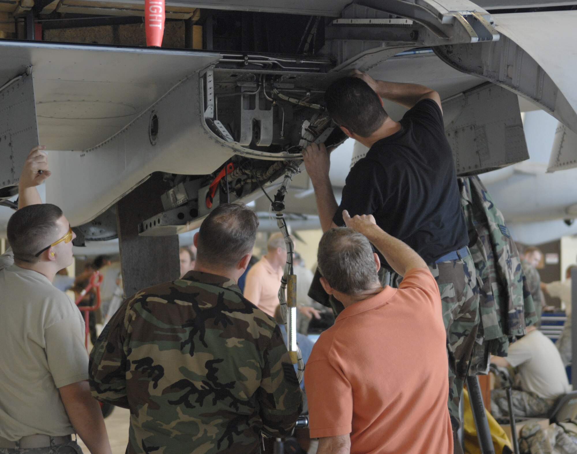MOODY AIR FORCE BASE, Ga. -- An Airman looks inside the trunnion of an A-10C Thunderbolt II here Nov. 7. The trunnion is the attachment point of the main landing gear and wing, which receives stress that causes cracks. (U.S. Air Force Photo by Senior Airman Javier Cruz)