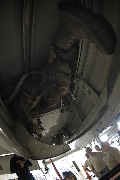 MOODY AIR FORCE BASE, Ga. -- An Airman climbs in a wing compartment in an A-10C Thunderbolt II here Nov. 7. Many maintainers were part of training that taught them how to repair major cracks on an A-10. (U.S. Air Force Photo by Senior Airman Javier Cruz)
