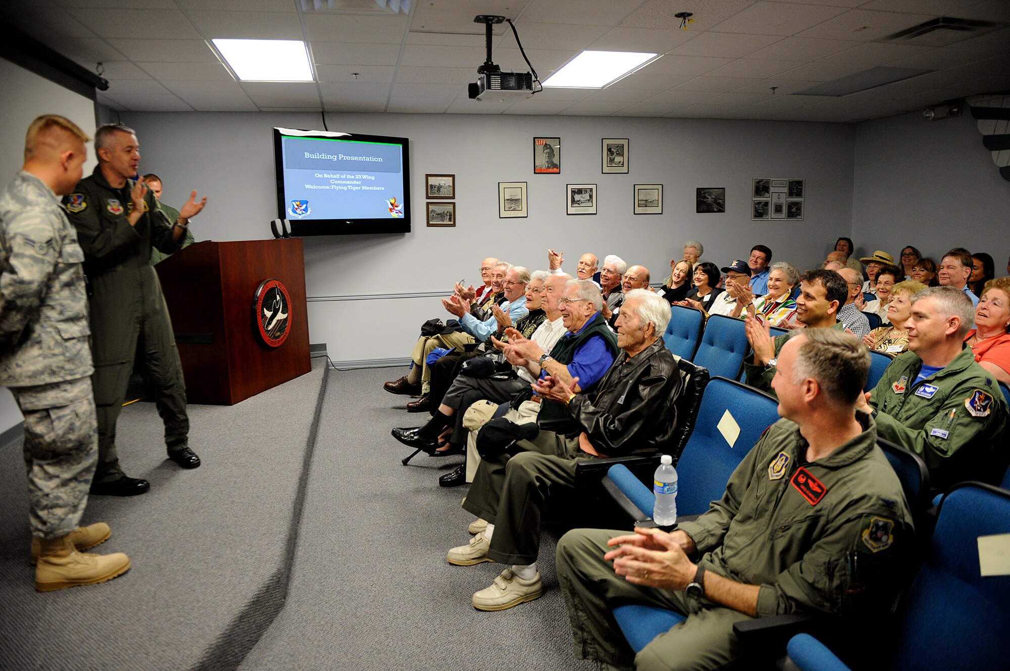 MOODY AIR FORCE BASE, Ga. – Col. Kenneth E. Todorov, 23rd Wing commander, and members of the Flying Tiger reunion clap for Airman 1st Class William Chennault, descendent of Lt. General Claire Chennault here Nov. 7. General Chennault founded the Flying Tigers, originally a volunteer group and started training in 1941. (U.S. Air Force photo by Senior Airman Brittany Barker) 