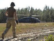 MOODY AIR FORCE BASE, Ga. -- During a week-long deployment training exercise the 41st Rescue Squadron performed a variety of sorties ranging from recovering injured pilots to in-flight refueling here November 6. After subduing the enemy threat, a HH-60G Pave Hawk lands and the simulated pilot emerges to signal the end of the training mission. (U.S. Air Force Photo by Senior Airman Javier Cruz)
