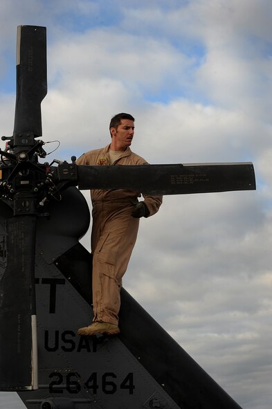 MOODY AIR FORCE BASE, Ga. – Tech. Sgt. Randy VanHorn, 41st Rescue Squadron flight engineer, performs preflight checks on an HH-60G Pave Hawk during war week here Nov. 5. War week is a week-long pre-deployment training  exercise to help the squadron plan, prepare and fight. (U.S. Air Force photo by Senior Airman Gina Chiaverotti)