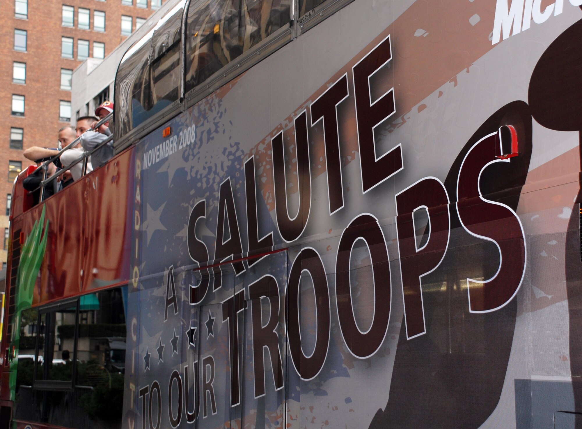 Wounded servicemembers in New York for "A Salute to Our Troops" weekend, hosted by United Service Organizations and Microsoft, sit atop a double-decker sight-seeing bus after arriving at the city's Penn Station. (Defense Department photo/Samantha L. Quigley)