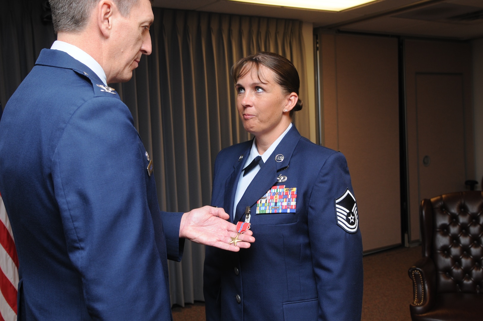Col. Dan Badger (left), Air Force Manpower Agency commander, pins a Bronze Star on then-Master Sgt. Andrea Vigliotti, AFMA, for meritorious service while serving as deputy of acquisition policy and evaluations at the Joint Contracting Command-Iraq/Afghanistan in Baghdad. Sergeant Vigliotti was also honored that day when she was promoted to the top two percent of the Air Force by earning her senior master sergeant stripe. (U.S. Air Force photo by Rich McFadden)