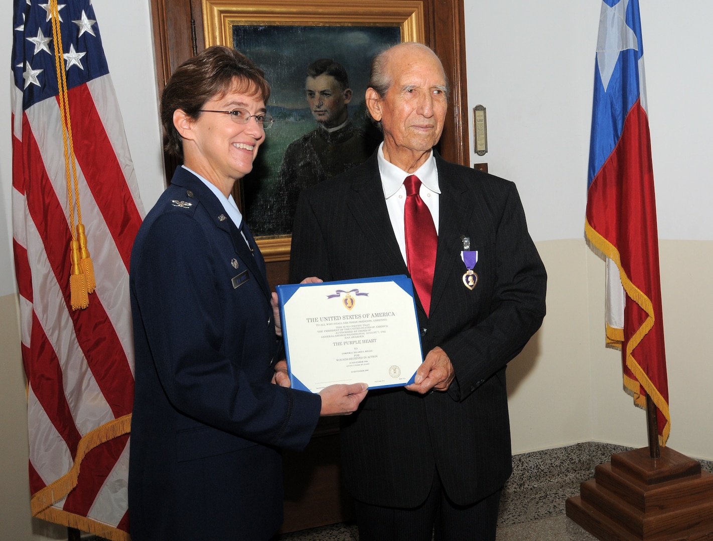 Col. Jacqueline Van Ovost, 12th Flying Training Wing command, presents the Purple Heart to World War II veteran Hilario Riojas, a former Army Air Forces corporal, who was wounded by artillery shell shrapnel during a battle in Germany more than 60 years ago. (U.S. Air Force photo by Melissa Peterson)