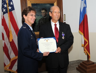 Col. Jacqueline Van Ovost, 12th Flying Training Wing command, presents the Purple Heart to World War II veteran Hilario Riojas, a former Army Air Forces corporal, who was wounded by artillery shell shrapnel during a battle in Germany more than 60 years ago. (U.S. Air Force photo by Melissa Peterson)