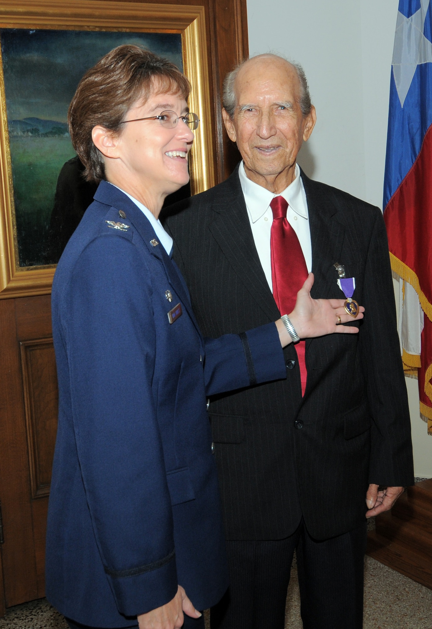Col. Jacqueline Van Ovost, 12th Flying Training Wing command, presents the Purple Heart to World War II veteran Hilario Riojas, a former Army Air Forces corporal, who was wounded by artillery shell shrapnel during a battle in Germany more than 60 years ago. (U.S. Air Force photo by Melissa Peterson)