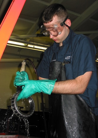 Airman 1st Class Joseph Dooley washes wheel bearings in a parts washer at the wheel and tire shop on Charleston AFB Nov. 10.  The 437th Maintenance Squadron Wheel and Tire Shop completed 462 wheel and tires during October, beating the Air Force record of most tires processed in one month.  Airman Dooley is an aerospace propulsion journeyman with the 437 MXS. (U.S. Air Force photo/Staff Sgt. Jennifer Arredondo)