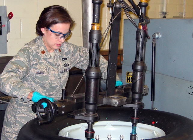 Maj. Sara Huiss tightens down the last of the bolts and nuts on the 462nd wheel breaking  the record of wheel and tire inspections completed in one here Oct. 31.  The 437th Maintenance Squadron Wheel and Tire Shop completed 462 inspections during October, beating the base and Air Force record of most tires processed in one month.  Major Huiss is the 437 MXS commander. (Courtesy photo)