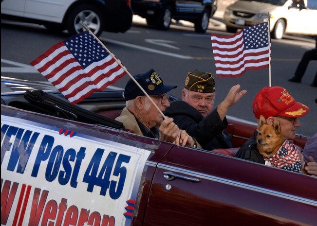 Veterans from World War II ride down the street and wave at the crowd during the Veterans Day parade in downtown Charleston Nov.9. Retirees, active-uty members and former prisoners of war from all branches of the armed forces joined together to celebrate Veterans Day. (U.S. Air Force photo/Senior Airman Timothy Taylor)