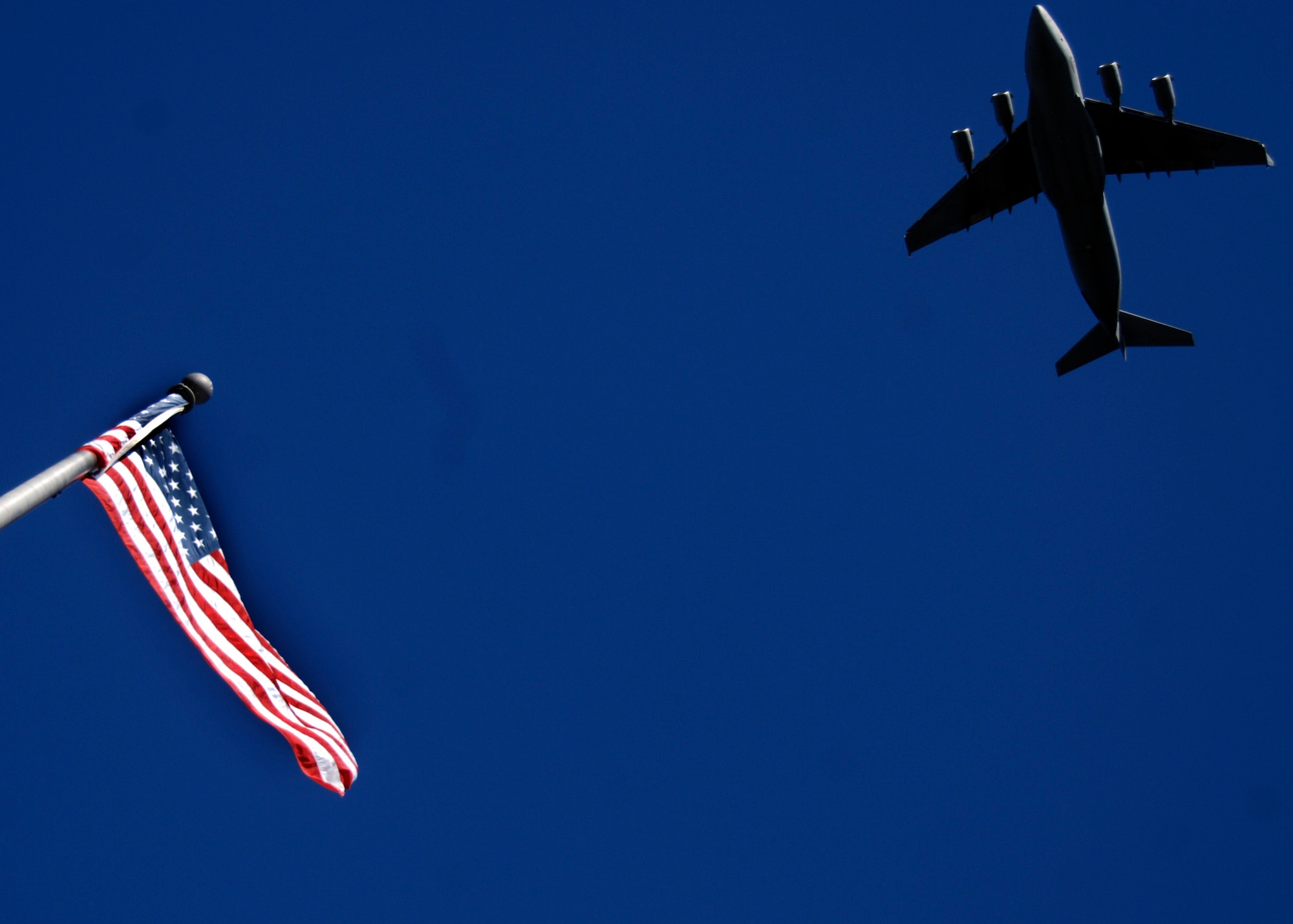 A Charleston AFB C-17 does a fly-by to begin the Veterans Day parade in downtown Charleston Nov. 9. Retirees, active-duty members and former prisoners of war from all branches of the armed forces joined together to celebrate Veterans Day. (U.S. Air Force photo/Senior Airman Timothy Taylor)
