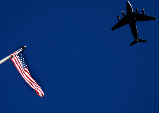 A Charleston AFB C-17 does a fly-by to begin the Veterans Day parade in downtown Charleston Nov. 9. Retirees, active-duty members and former prisoners of war from all branches of the armed forces joined together to celebrate Veterans Day. (U.S. Air Force photo/Senior Airman Timothy Taylor)