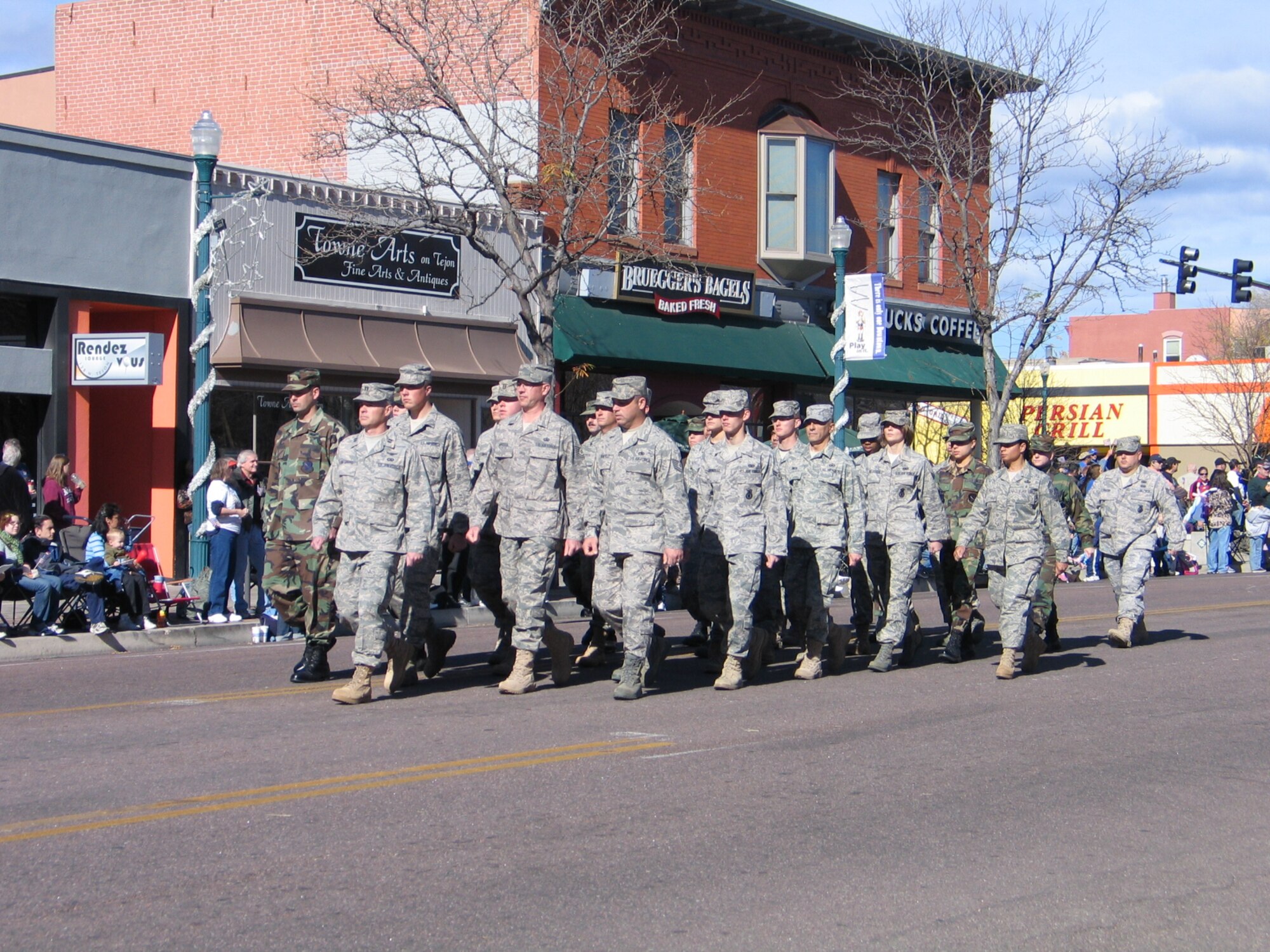 Airmen from Peterson and Schriever Air Force bases march down Tejon Street during the annual Colorado Springs Veterans Day parade Nov. 8. More than 100 floats, bands, military units and more participated in the salute to veterans, including a flyover by a C-130 from the 302nd Airlift Wing. Parade officials estimate more than 30,000 spectators turned out for the event. (U.S. Air Force photo/Steve Brady)