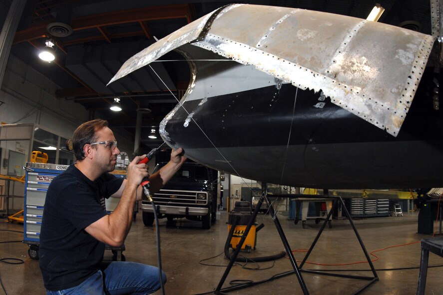 OFFUTT AIR FORCE BASE, Neb. -- Jim Battig, an aircraft sheet metal mechanic with the 55th Maintenance Squadron, drills out rivets on a horizontal stabilizer from a B17 Bomber static display Nov. 5. The staff members from the 55th Maintenance Squadron's body shop are doing a complete frame-off restoration of this historic airframe.  

U.S. Air Force Photo by Josh Plueger