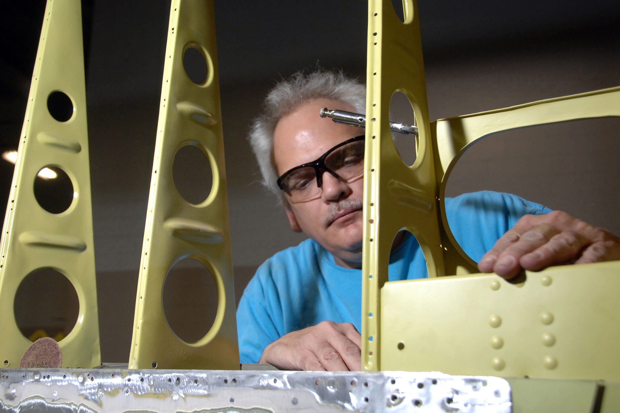 OFFUTT AIR FORCE BASE, Neb. -- Walter Chapman, an aircraft sheet metal technician with the 55th Maintenance Squadron, works on the access panel of a B17 horizontal stabilizer Nov. 5. The corroded metal was replaced and primed as part of a lengthy frame-off restoration on this historic air frame located near the  SAC gate here.

U.S. Air Force Photo by Josh Plueger
