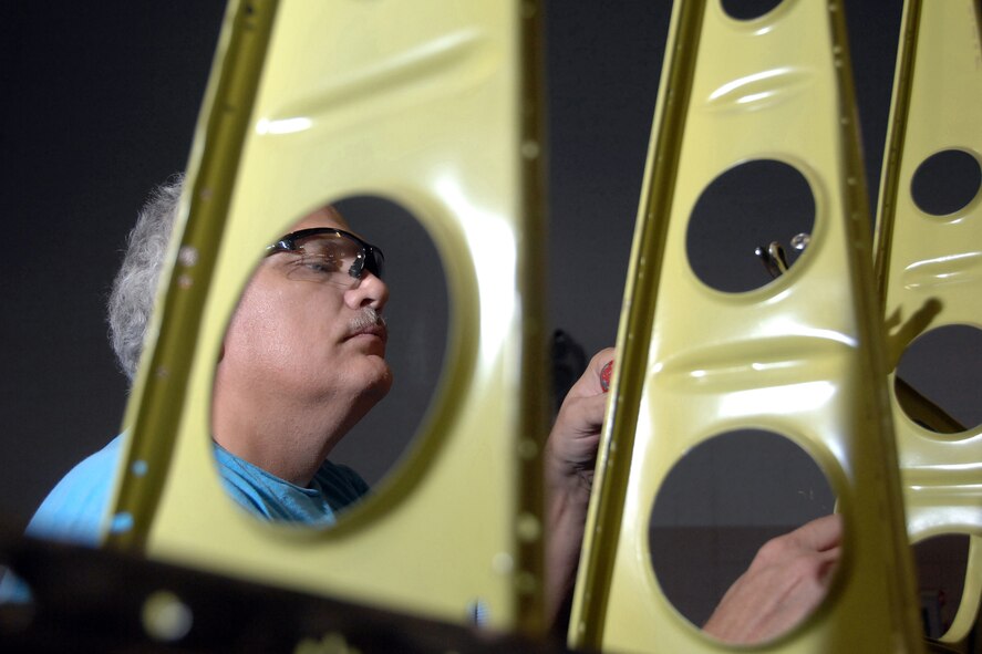 OFFUTT AIR FORCE BASE, Neb. -- Walter Chapman, an aircraft sheet metal technician with the 55th Maintenance Squadron, works on the access panel of a B17 horizontal stabilizer Nov. 5. All thel corroded metal was replaced and primed as part of a lengthy frame-off restoration on this historic air frame located near the SAC gate here. U.S. Air Force Photo by Josh Plueger