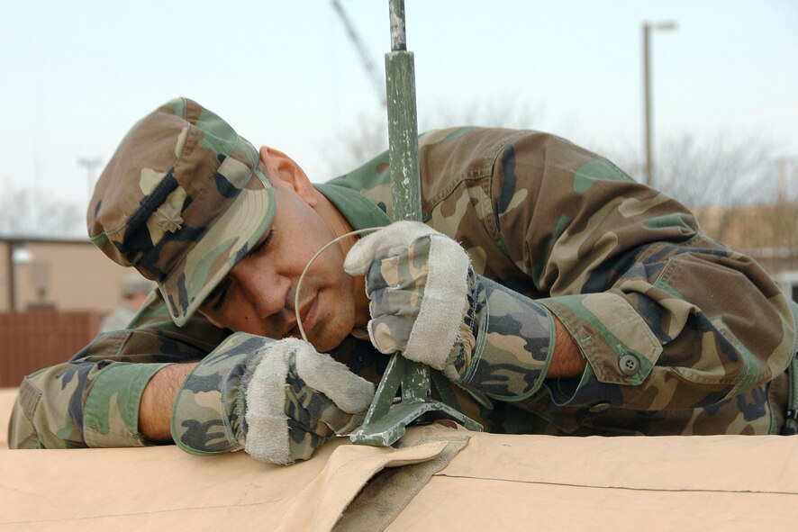 OFFUTT AIR FORCE BASE, Neb., -Maj Juan Ubiera Jr., 55th Medical Group public health flight commander, places an eve extender on top of the medical tent in preparation for an operational readiness exercise Nov. 5. This operational readiness exercise extends through Nov. 7. (Photo By: Mr. Charles Haymond). 