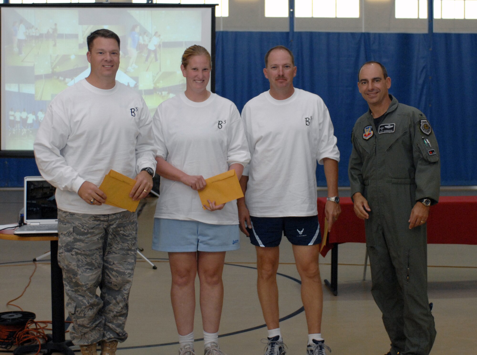 The Biggest Loser team, Batten?s Belly Busters, poses with Col. Jeff Harrigian, 49th Fighter Wing commander, after being announced the team with the most points during the Biggest Loser awards ceremony at the Fitness and Sports Center at Holloman Air Force Base, N.M., Oct. 31. The team members include (from left to right) Maj. Jason Campbell, Staff Sgt. Shannon Thomas, Master Sgt. James Thomas and (not photographed) Lt. Col. Melissa Batten, all from the 49th Logistics Readiness Squadron. Batten?s Belly Busters obtained 16,095 points total during the 12-week competition. Teams gained points by participating in daily lunch-time walks and fitness classes, turning in nutrition logs, weekly weigh-ins and team challenges. (U.S. Air Force photo/Airman Sondra M. Escutia)