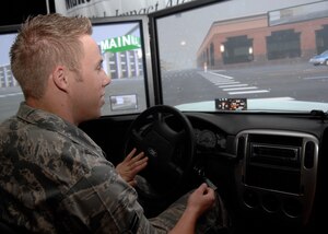 Airman 1st Class Kyle Moline drives a drunk driving simulator during the Save A Life Tour at the base theater Nov. 7. The Save A Life Tour also included a 12-minute video with graphic scenes to show the reality and severity of drunk driving consequences. Airman Moline is with the 437th Logistics Readiness Squadron. (U.S. Air Force photo/Airman 1st Class Katie Gieratz) 
