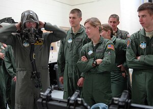 Cadet 3rd Class Zackery Williams tries on aircrew chemical defense gear at Aircrew Flight Equipment on Charleston AFB Nov. 8. Cadets toured the base to learn more about the operational Air Force mission. Cadet Williams is a student at the Air Force Academy. (U.S. Air Force photo/Airman 1st Class Katie Gieratz)