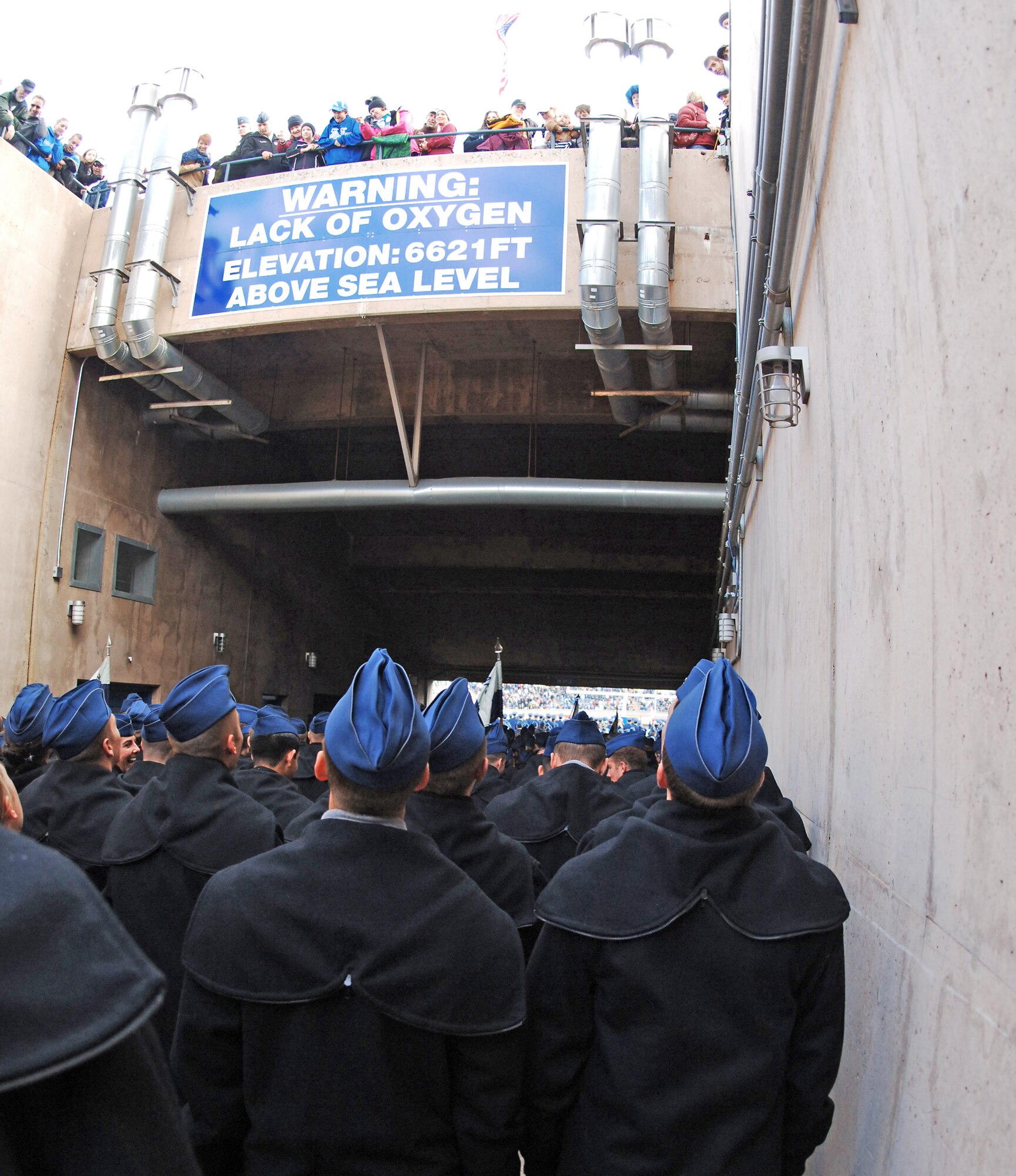 Cadets from the Unites States Air Force Academy look up as spectators toss goodies from above as they wait to enter the field before a football game against Colorado State University Nov. 8 at at Falcon Stadium in Colorado.  The Falcons went on to beat the Rams 38-17, advancing their record 8-2, which is its best 10-game record since 1998 when the team opened 9-1. (U.S. Air Force photo/Tech. Sgt. Christopher DeWitt)