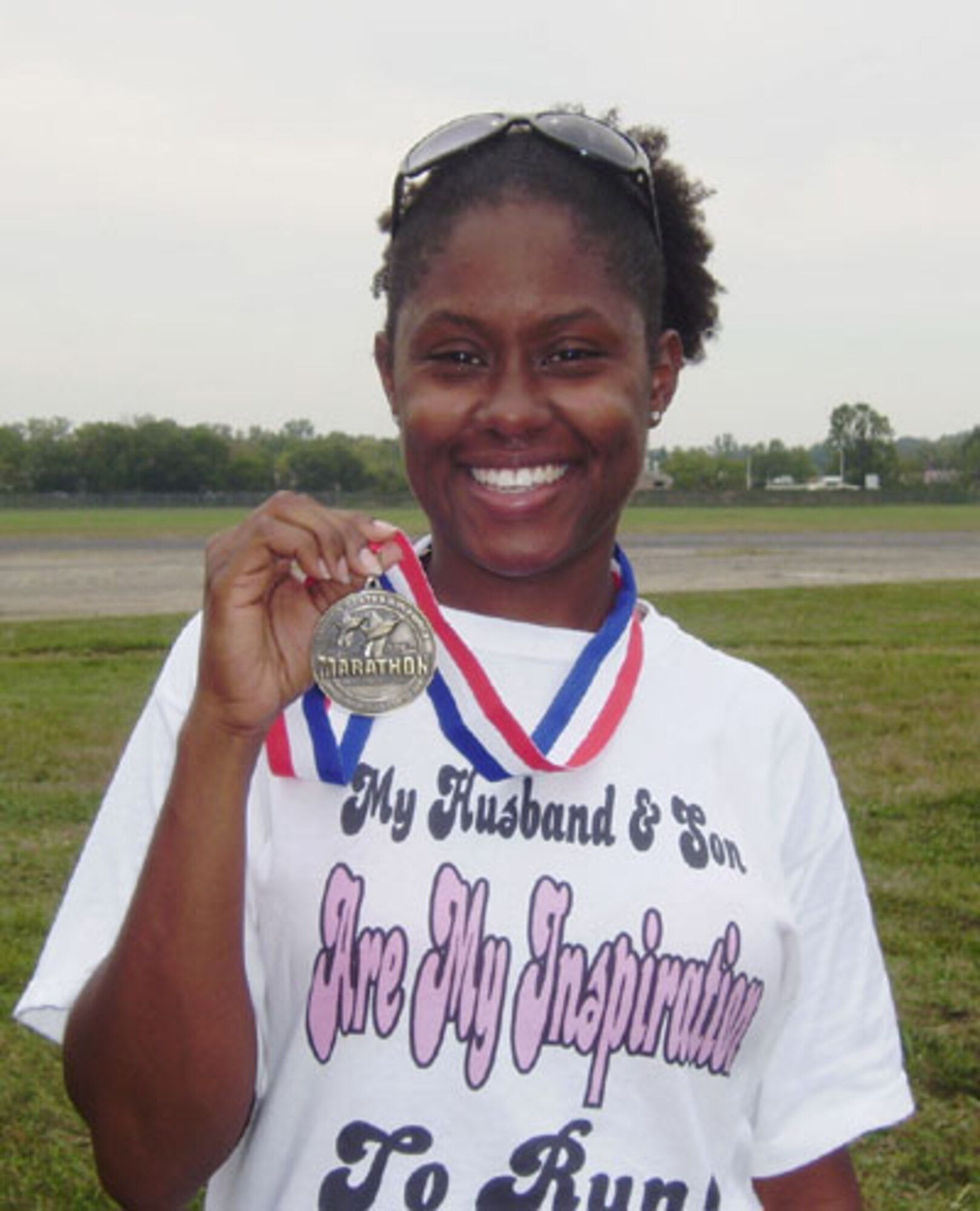 Air Force Reservist Capt. Rubannette Jenkins, 507th Air Refueling Wing Military Equal Opportunity officer proudly wears her motivational T-shirt and medal from the Air Force marathon. 