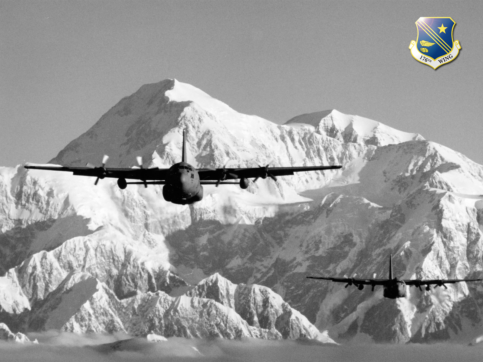 C-130s from the Alaska Air National Guard's 176th Wing fly near Mt. McKinley.