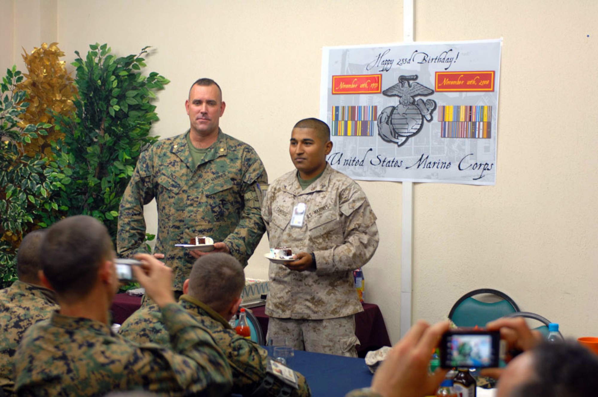 Marines Lance Cpl. German Gamez Campos and Maj. Jay Rice cut and pass out the first pieces of the birthday cake in celebration of the Marine Corps' 233rd birthday at Manas Air Base, Kyrgyzstan, Nov. 10. The group of 30 Marines deployed from the 3rd Marine Division, Okinawa, are en route to support Operation Enduring Freedom. (U.S. Air Force photo/Tech. Sgt. Michael Voss)