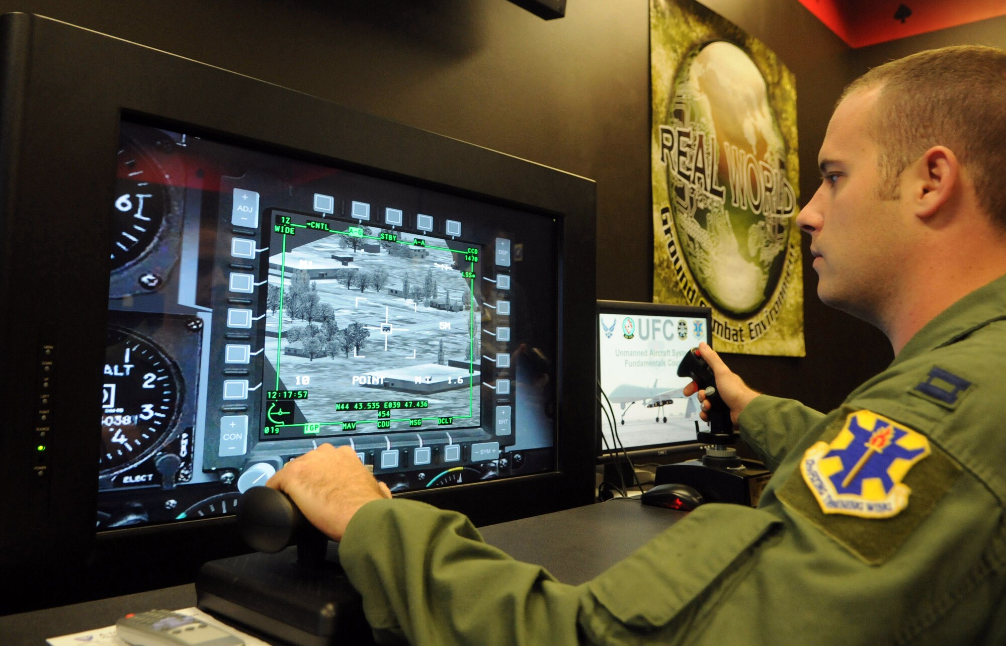 Capt. Sam Allen, 563rd Flying Training Squadron instructor and Unmanned Aircraft Systems Fundamentals Course director at Randolph Air Force Base, Texas, operates the controls of a battlespace simulator in the course's laboratory. (U.S. Air Force photo/Rich McFadden) 