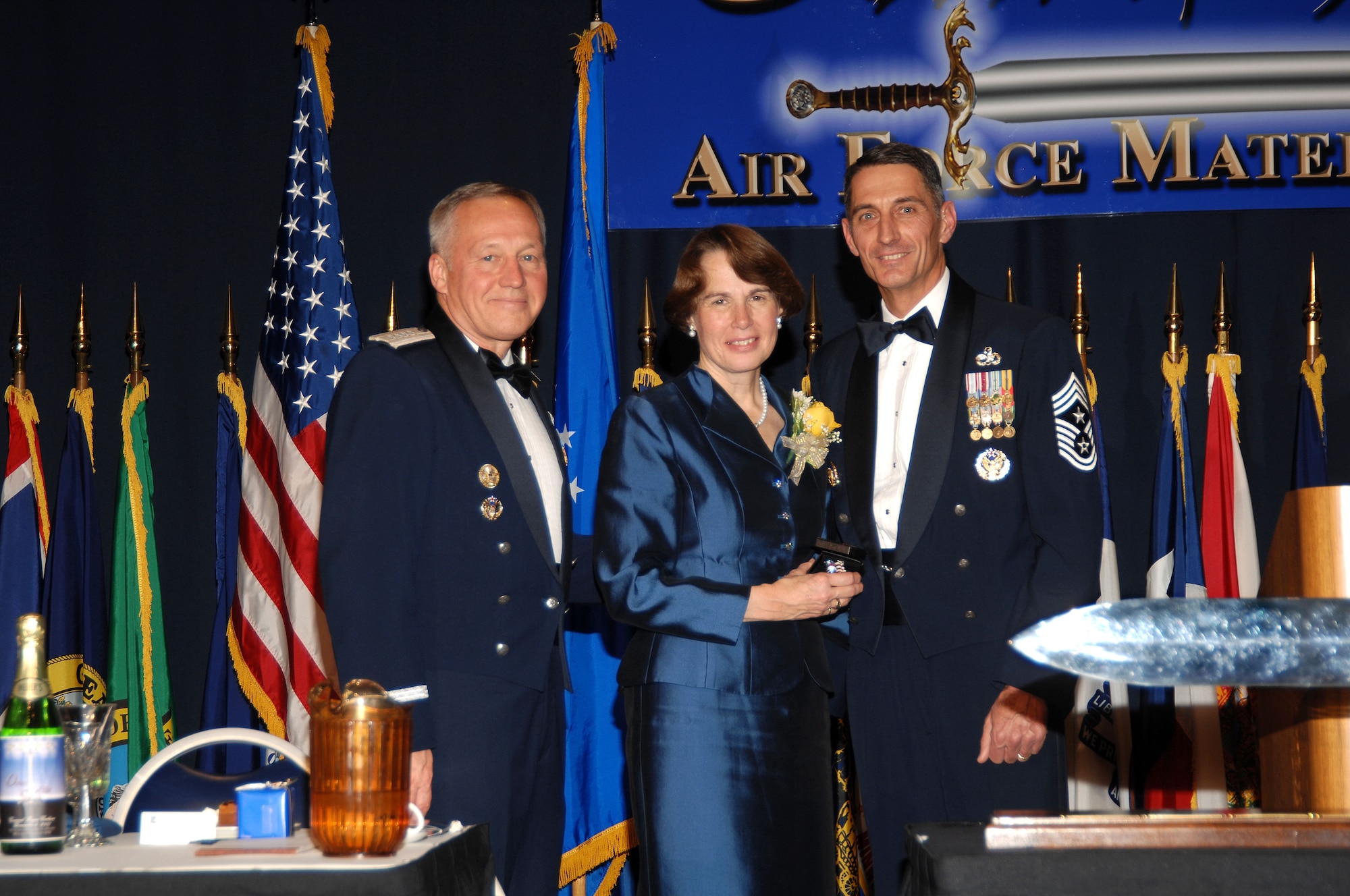 Gen. Bruce Carlson (left), is joined by his wife, Vicki, and the former AFMC command chief, Chief Master Sgt. Jonathan Hake, during General Carlson’s Order of the Sword ceremony. The event took place at the National Museum of the U.S. Air Force on Dec. 6, 2007. (Air Force photo by Ben Strasser)