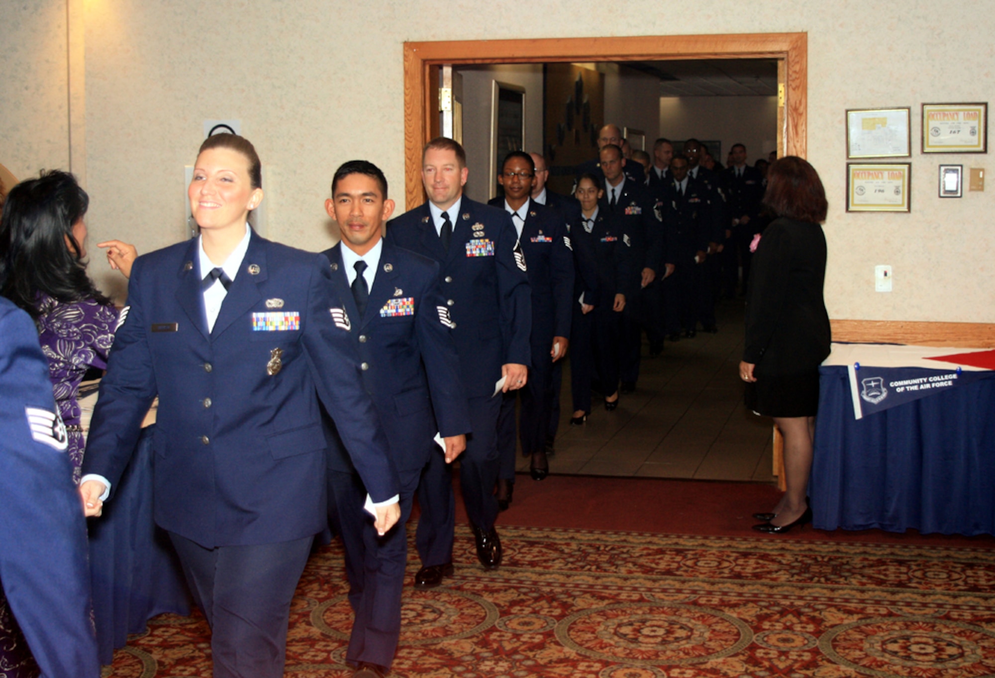 Team McGuire Community College of the Air Force Fall 2008 graduates head into their graduation ceremony held recently at The Club. The CCAF, an institution of higher learning, incorporates the Air Force's core values of integrity first, service before self and excellence in all we do, to prepare the world's best expeditionary-minded air, space and cyberspace enlisted leaders. (U.S. Air Force photo/Wayne Crist)