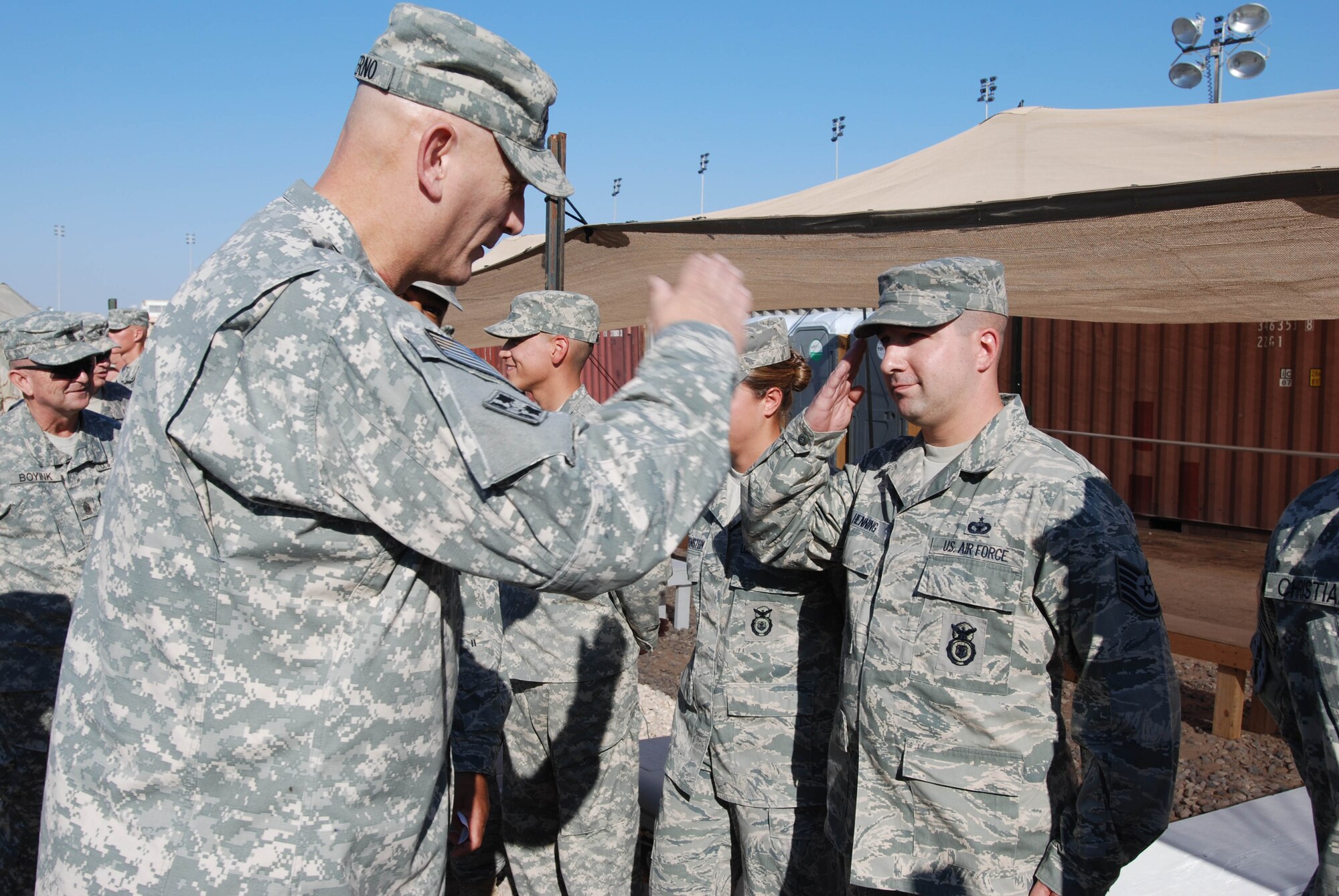 CAMP BUCCA, IRAQ - Tech. Sgt. Christopher Henning, 586th Expeditionary Security Forces Squadron, receives a coin from Army Gen. Raymond T. Odierno, Multi National Forces Iraq commander. Sergeant Henning, deployed from Cannon AFB, N.M., was selected by unit leaders to be one of two unit members assigned to the 586th ESFS to receive a coin from General Odierno. Sergeant Henning was chosen for the Nov. 8 presentation based on his outstanding leadership and duty performance. (U.S. Air Force photo)