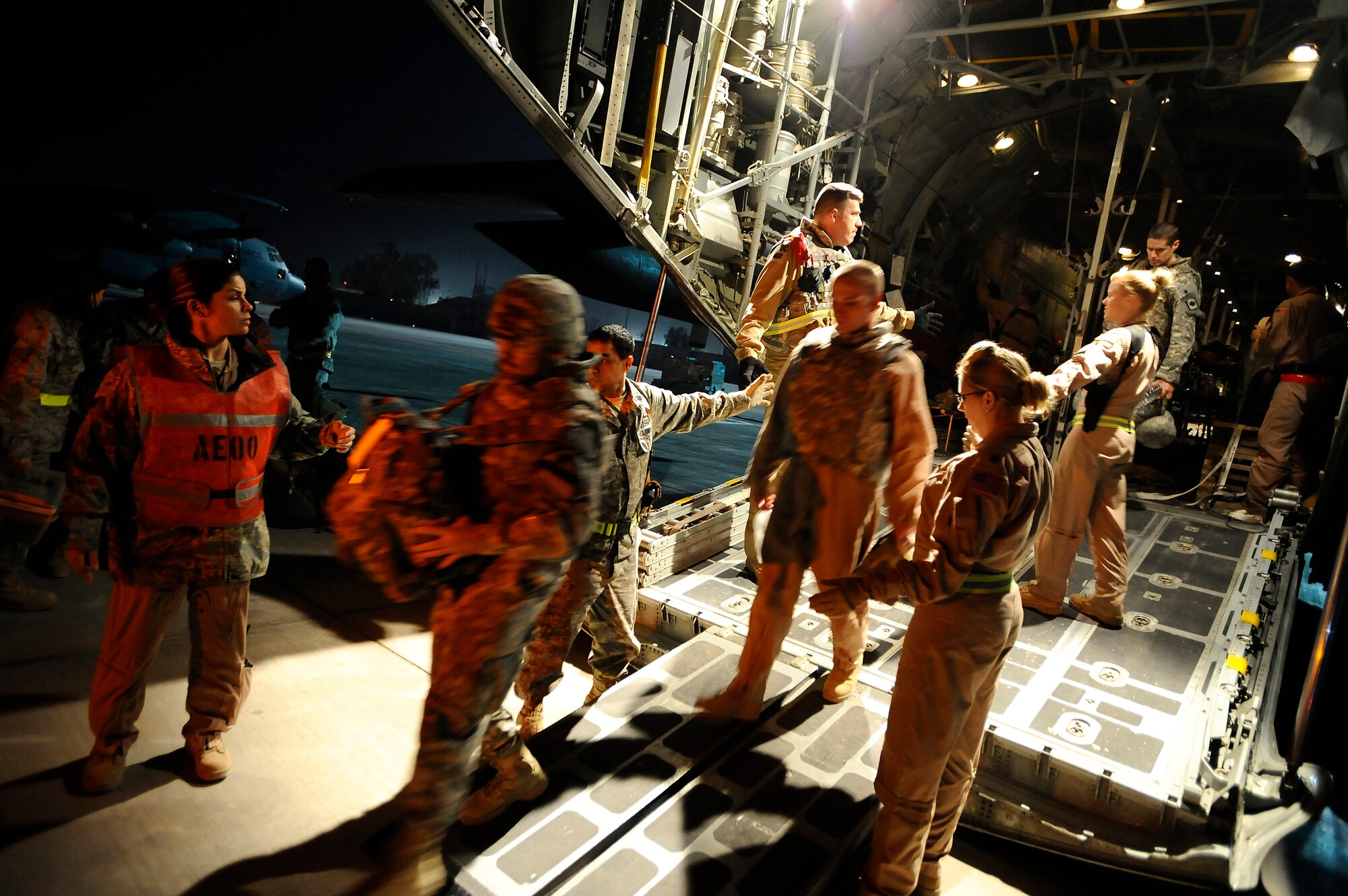 Ambulatory patients depart a C-130 Hercules assigned to the 777th Expeditionary Airlift Squadron at Joint Base Balad, Iraq, shortly after midnight Nov. 8. Two Iraqi doctors from Iraq's Ministry of Defense accompanied an aeromedical evacuation mission to study U.S. Air Force aeromedical evacuation procedures so that they can establish an aeromedical evacuation service for the Iraqi air force. The C-130 is deployed from the Wyoming Air National Guard's 153rd Airlift Wing. (U.S. Air Force photo/Airman 1st Class Jason Epley)