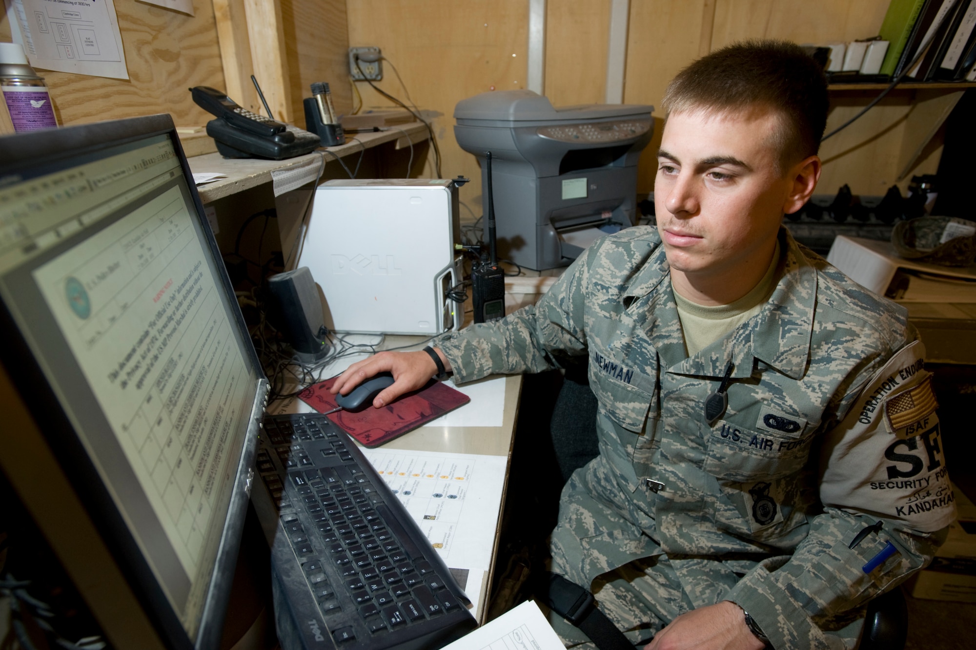 KANDAHAR AIR FIELD, Afghanistan -- Airman 1st Class Matt Newman enters information into the police blotter. Airman Newman is deployed to the 755th Expeditionary Security Forces Squadron Law and Order Unit from Peterson Air Force Base, Colo. Airmen assigned to the Law and Order unit are charged with enforcing traffic laws on the NATO base, handling reports of theft and other disturbances. (U.S. Air Force photo/Master Sgt. Keith Brown)