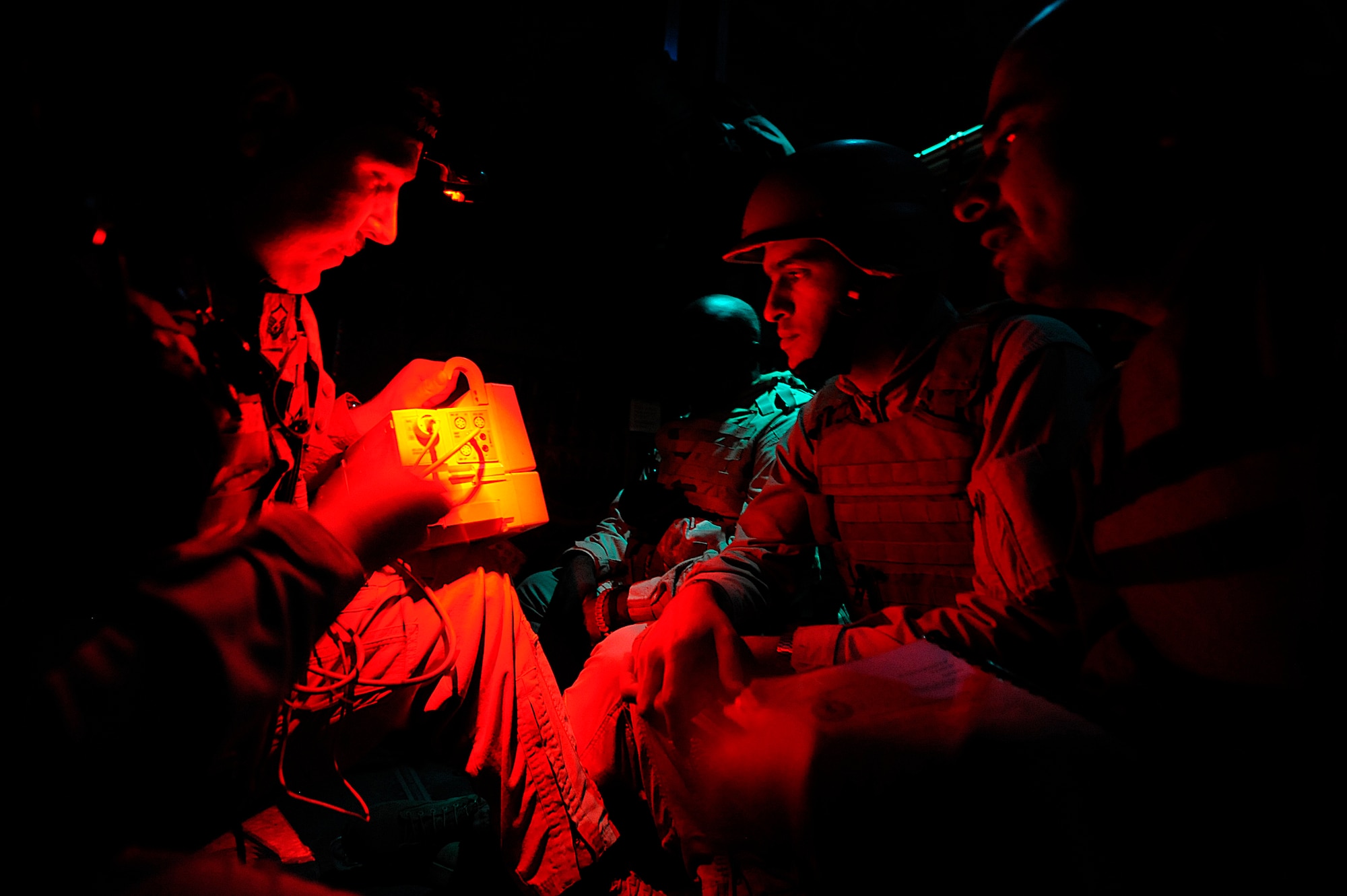 Master Sgt. Scott Wilkes demonstrates a Propaq system to Iraqi air force Capt. (Dr.) Mohammed and Iraqi air force Maj. (Dr.) Abdul-Razaq during an aeromedical evacuation mission over Iraq Nov. 7. The device measures a patient's blood pressure, oxygen levels, heart rate, ECG and body temperature. The two Iraqi doctors from Iraq's Ministry of Defense accompanied the U.S. Air Force mission to study aeromedical evacuation procedures so that they can establish an aeromedical evacuation service for the Iraqi air force. Wilkes, a charge medical technician assigned to the 332nd Expeditionary Aeromedical Evacuation Flight, is deployed from McGuire Air Force Base, N.J. (U.S. Air Force photo/Airman 1st Class Jason Epley)