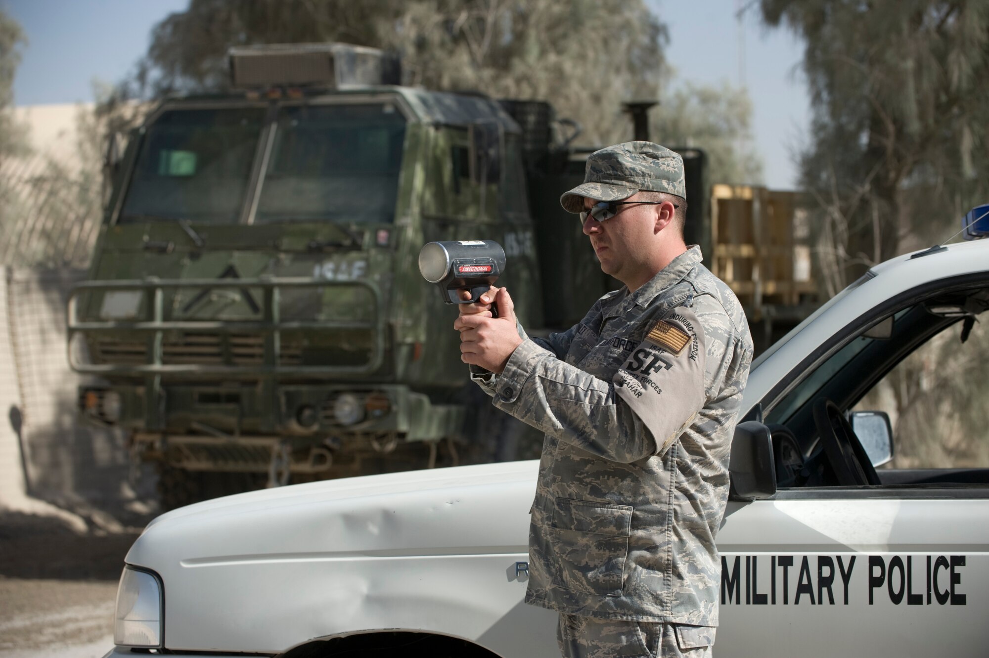 KANDAHAR AIR FIELD, Afghanistan -- Staff Sgt. Gary Riley, 755th Expeditionary Security Forces Squadron Law and Order Unit, runs radar on a busy street here. Airmen assigned to the law and order unit are charged with enforcing traffic laws on the NATO base, handling reports of theft and other disturbances. Sergeant Riley is deployed here from MacDill Air Force Base, Fla. (U.S. Air Force photo/Master Sgt. Keith Brown)
