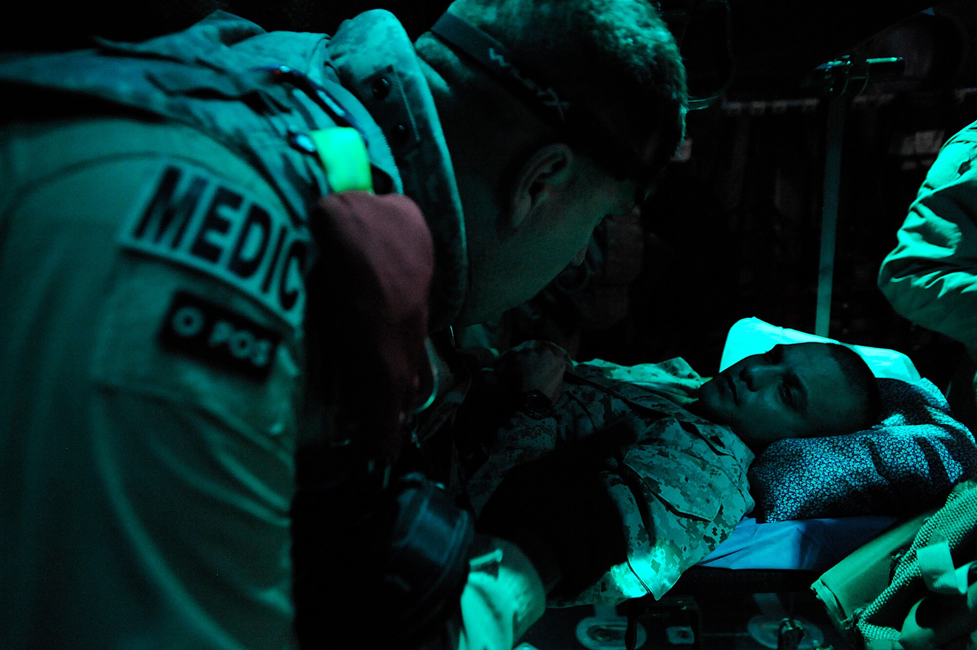 Master Sgt. Scott Wilkes checks on Marine Lance Cpl. Geroge Diaz during an aeromedical evacuation mission over Iraq Nov. 7. Two Iraqi doctors from Iraq's Ministry of Defense accompanied the U.S. Air Force mission to study aeromedical evacuation procedures so that they can establish an aeromedical evacuation service for the Iraqi air force. Wilkes, a charge medical technician with the 332nd Expeditionary Aeromedical Evacuation Flight, is deployed from McGuire Air Force Base, N.J. (U.S. Air Force photo/Airman 1st Class Jason Epley)
