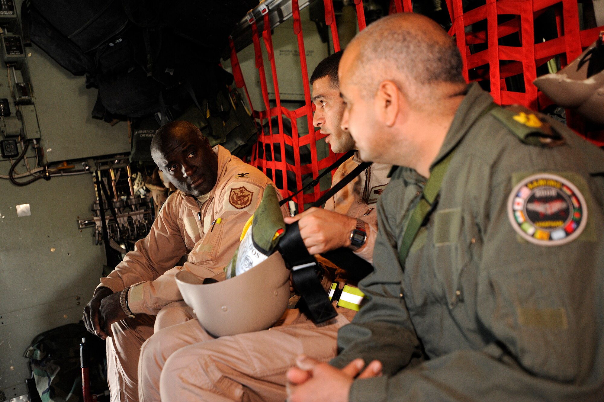 Col. (Dr.) Paul Young converses with Iraqi air force Capt. (Dr.) Mohammed and Iraqi air force Maj. (Dr.) Abdul-Razaq before departing on an aeromedical evacuation mission over Iraq Nov. 7. The two Iraqi doctors from Iraq's Ministry of Defense accompanied the U.S. Air Force mission to study aeromedical evacuation procedures so that they can establish an aeromedical evacuation service for the Iraqi air force. Young, the surgeon general for the Coalition Air Forces Transition Team, is deployed from Ramstein Air Base, Germany. (U.S. Air Force photo/Airman 1st Class Jason Epley)