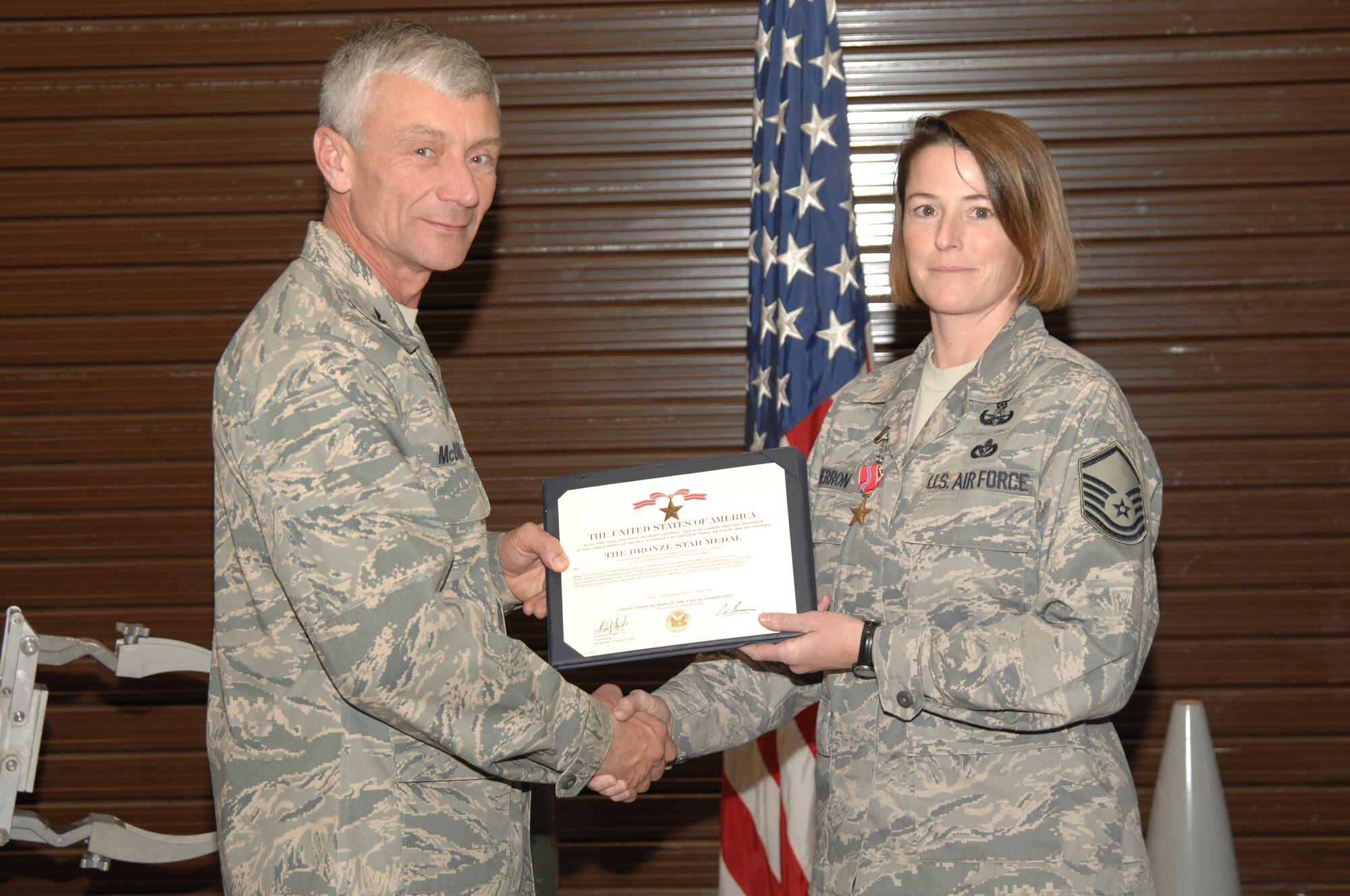 Col. Phil McDaniel, 39th Air Base Wing commander, presents Master Sgt. Krisah Herron with a Bronze Star. Sergeant Herron earned a Bronze Star as an Explosive Ordnance Disposal Team leader, 447th Explosive Ordnance Disposal Alpha Flight, Multi-National Force-Iraq, Baghdad. During Operation Iraqi Freedom, Sergeant Herron responded to 37 emergencies in a 919 square-kilometer area of operation including 10 improvised explosive devices, 11 weapons caches and three unexploded ordnances. (U.S. Air Force photo by Senior Airman Benjamin Wilson)