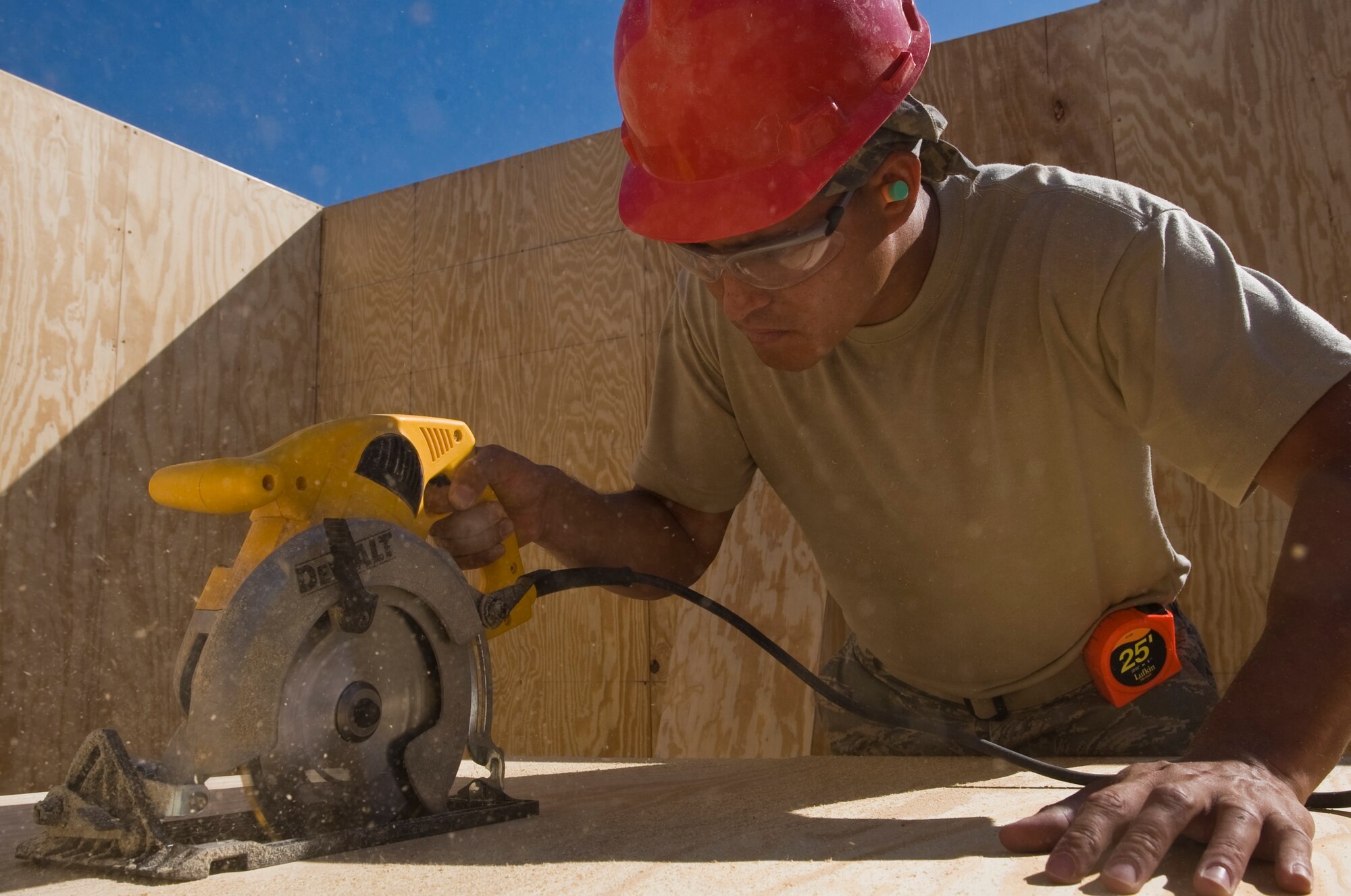 ALI BASE, Iraq -- Airman 1st Class Jerry Perez, 557th Expeditionary RED HORSE Squadron structural apprentice, cuts wood for the walls Nov. 7, 2008. The Airmen from the 557th ERHS look to improve work conditions by constructing a new unit work center here. Perez is deployed from Seymour Johnson Air Force Base, N.C. His hometown is Wichita, Kan. (U.S. Air Force photo/Senior Airman Christopher Griffin)