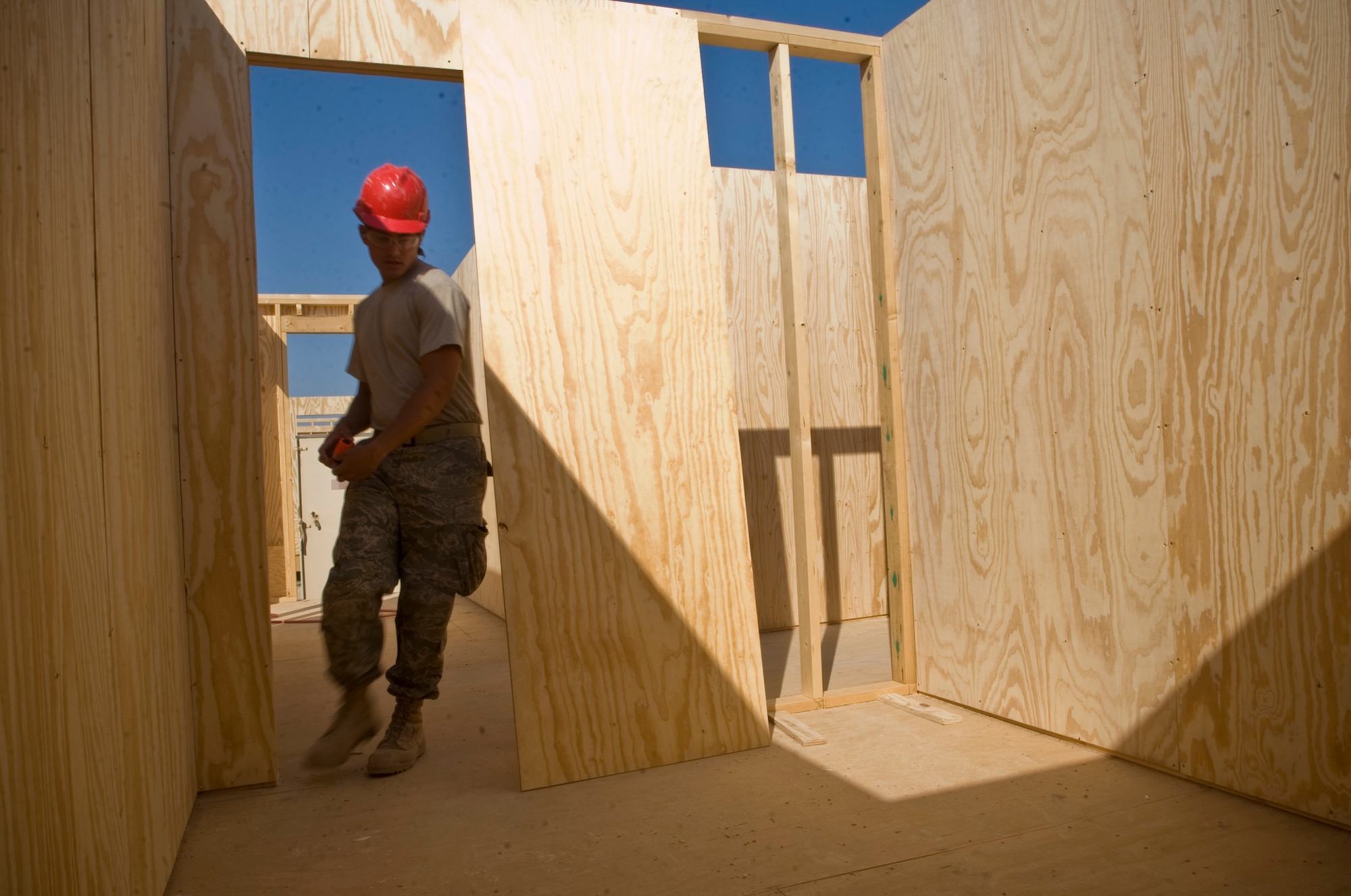 ALI BASE, Iraq -- Airman 1st Class Jerry Perez, 557th Expeditionary RED HORSE Squadron structural apprentice, prepares to mount the final piece of the wall to a room Nov. 7, 2008. The Airmen from the 557th ERHS look to improve work conditions by constructing a new unit work center here. Perez is deployed from Seymour Johnson Air Force Base, N.C. His hometown is Wichita, Kan. (U.S. Air Force photo/Senior Airman Christopher Griffin)