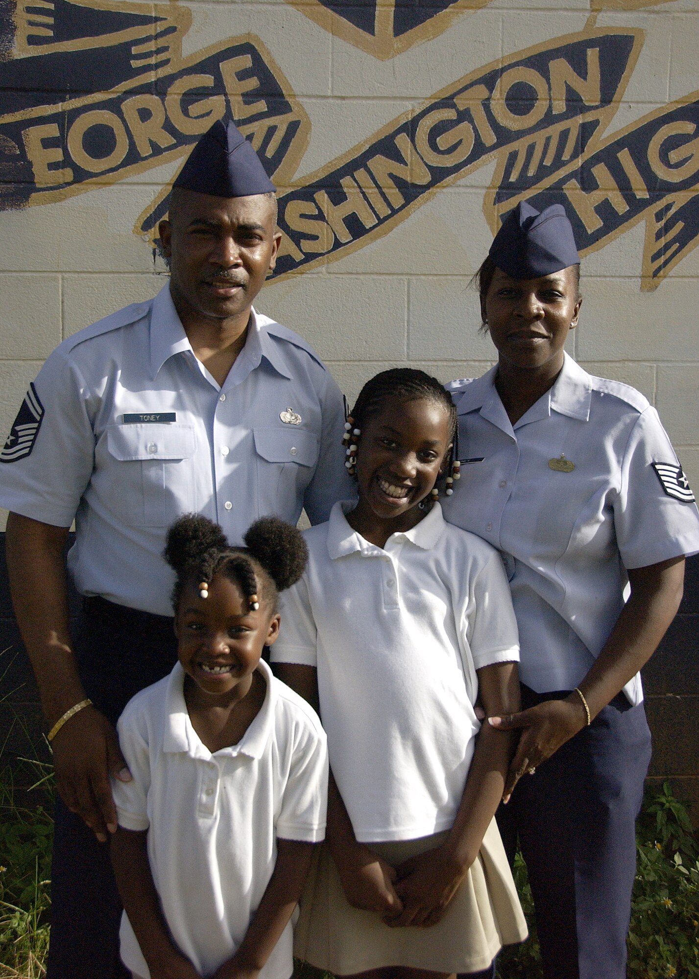 The Toney family consists of Senior Master Sgt. Jason Toney, 36th Force Support Squadron, Tech. Sgt. Travana Toney, 36th Wing, 8-year-oldBrianna Toney and 5-year-old Jordan Toney. The Toney family makes volunteering a joint effort, with new ideas coming from all members of the family. The Toney family most recently volunteered painting local George Washington High School. (U.S. Air Force photo by Airman 1st Class Carissa Wolff)
                    